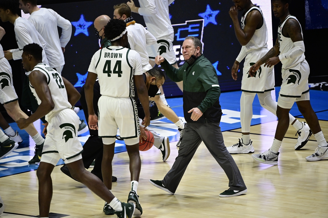 Mar 18, 2021; West Lafayette, Indiana, USA; Michigan State Spartans head coach Tom Izzo heads into the locker room as he talks with forward Gabe Brown (44) at half time during the First Four of the 2021 NCAA Tournament at Mackey Arena. Mandatory Credit: Marc Lebryk-USA TODAY Sports