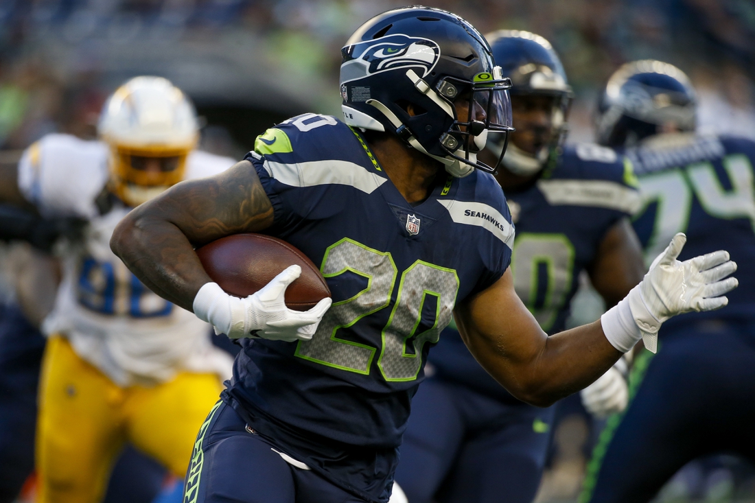 Aug 28, 2021; Seattle, Washington, USA; Seattle Seahawks running back Rashaad Penny (20) rushes against the Los Angeles Chargers during the first quarter at Lumen Field. Mandatory Credit: Joe Nicholson-USA TODAY Sports