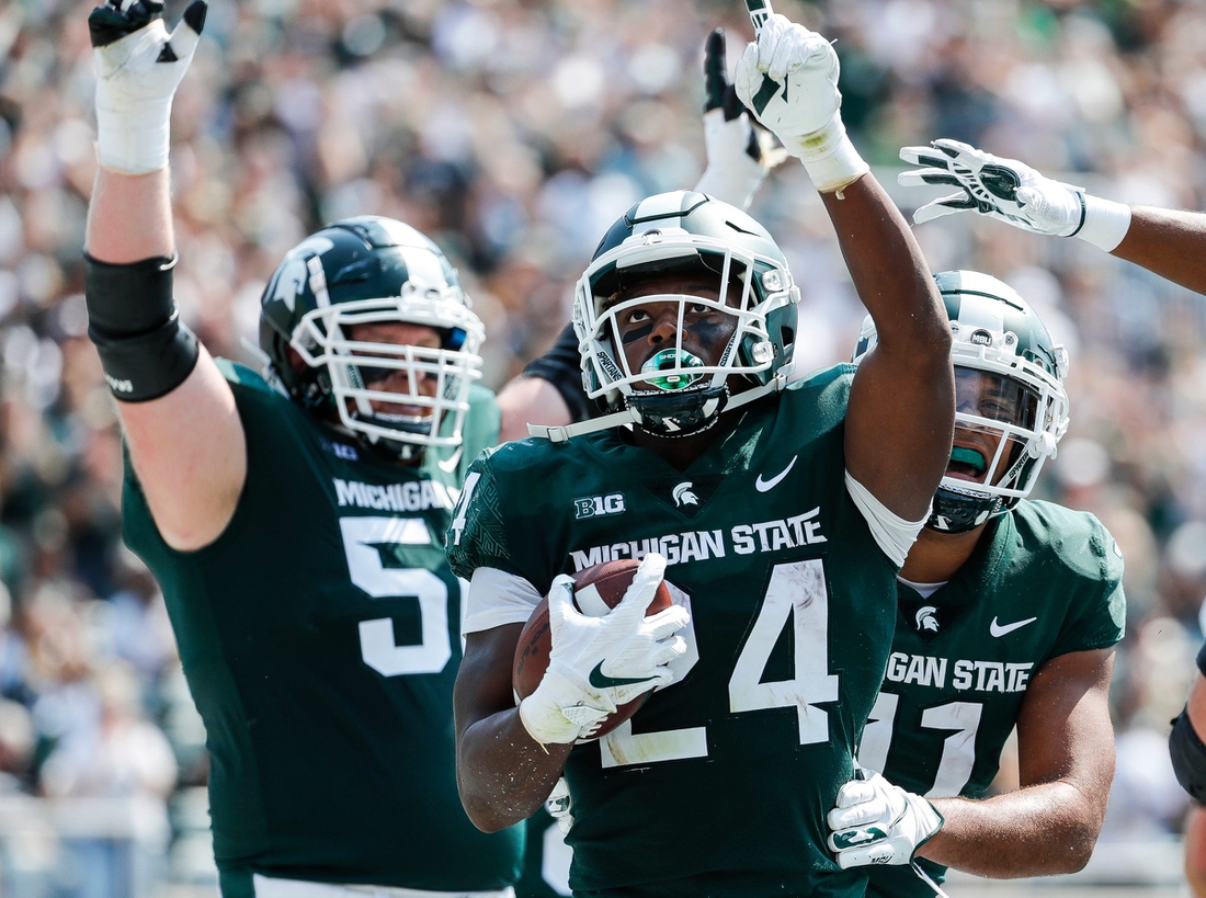 Michigan State running back Elijah Collins (24) celebrates a touchdown against Youngstown State during the first half at Spartan Stadium in East Lansing on Saturday, Sept. 11, 2021.