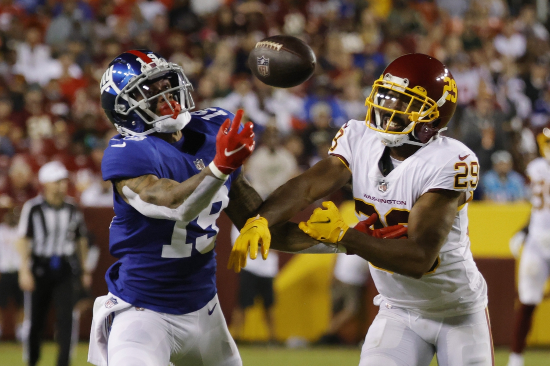 Sep 16, 2021; Landover, Maryland, USA; New York Giants wide receiver Kenny Golladay (19) attempts to make a catch as Washington Football Team cornerback Kendall Fuller (29) defends in the third quarter at FedExField. Mandatory Credit: Geoff Burke-USA TODAY Sports
