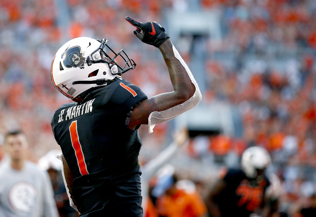 Sep 25, 2021; Stillwater, Oklahoma, USA;  Oklahoma State Cowboys wide receiver Tay Martin (1) celebrates after catching a touchdown pass against the Kansas State Wildcats in the second quarter at Boone Pickens Stadium. Mandatory Credit: Sarah Phipps-USA TODAY Sports