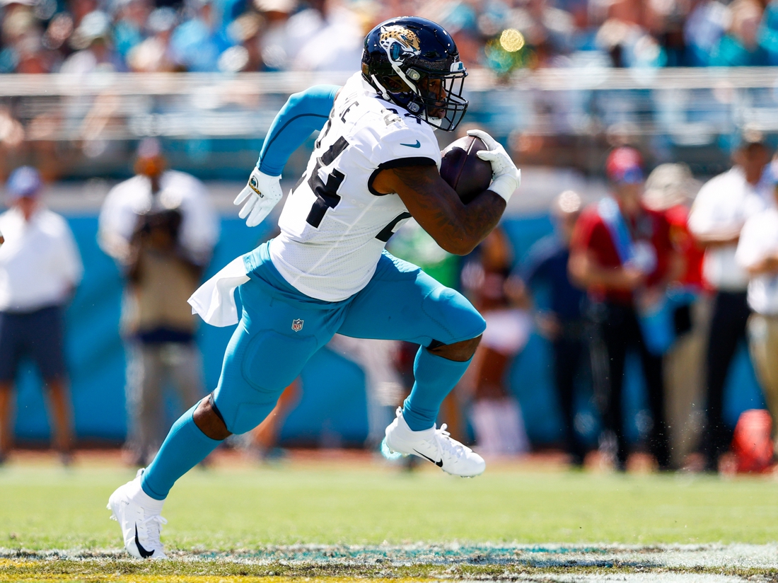 Sep 26, 2021; Jacksonville, Florida, USA; Jacksonville Jaguars running back Carlos Hyde (24) runs with the ball in the second quarter against the Arizona Cardinals at TIAA Bank Field. Mandatory Credit: Nathan Ray Seebeck-USA TODAY Sports