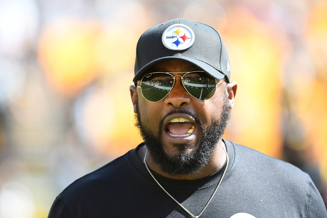 Sep 19, 2021; Pittsburgh, Pennsylvania, USA;  Pittsburgh Steelers head coach Mike Tomlin communicates with his team before playing the Las Vegas Raiders at Heinz Field. The Raiders won the game 26-17. Mandatory Credit: Philip G. Pavely-USA TODAY Sports