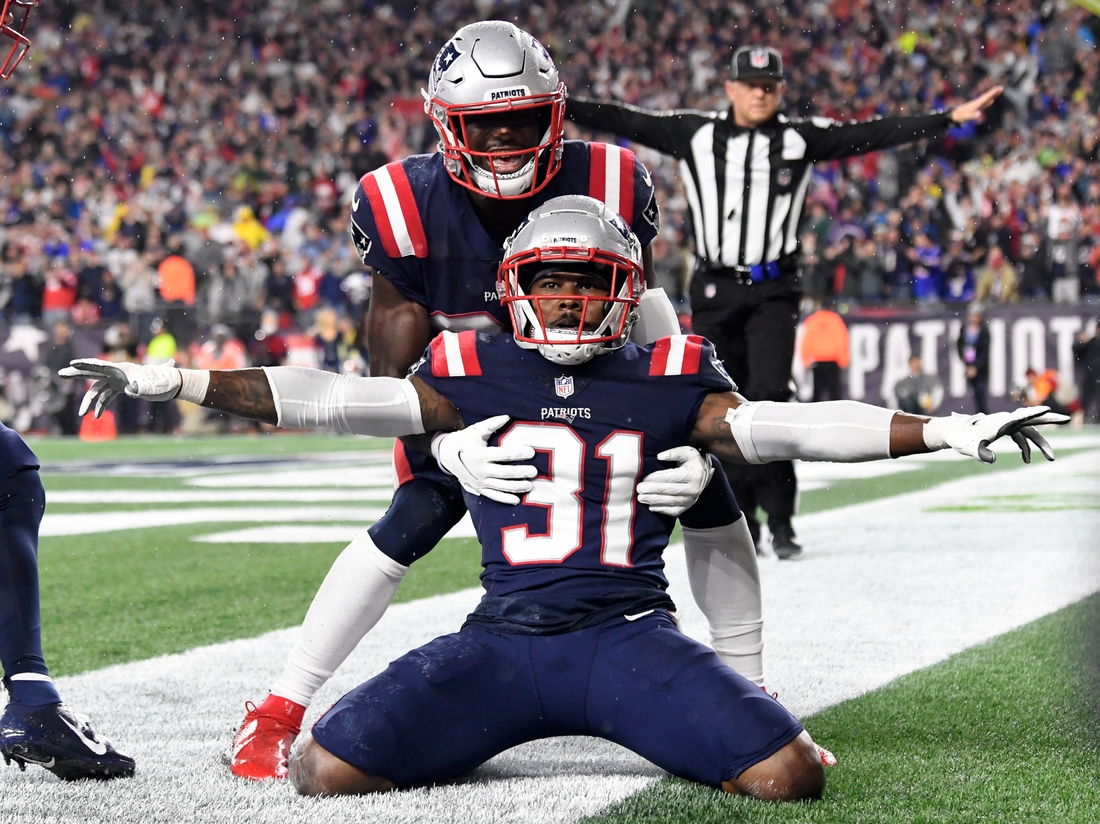 Oct 3, 2021; Foxborough, Massachusetts, USA;  New England Patriots free safety Devin McCourty (32) celebrates with defensive back Jonathan Jones (31) after breaking up a pass in the end zone during the second half of a game against the Tampa Bay Buccaneers at Gillette Stadium. Mandatory Credit: Brian Fluharty-USA TODAY Sports