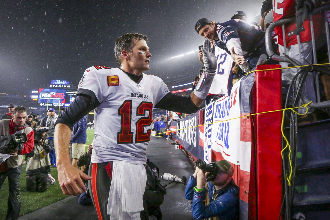 Oct 3, 2021; Foxboro, MA, USA; Tampa Bay Buccaneers quarterback Tom Brady (12) runs off the field after the win over the New England Patriots at Gillette Stadium.  Mandatory Credit: Paul Rutherford-USA TODAY Sports