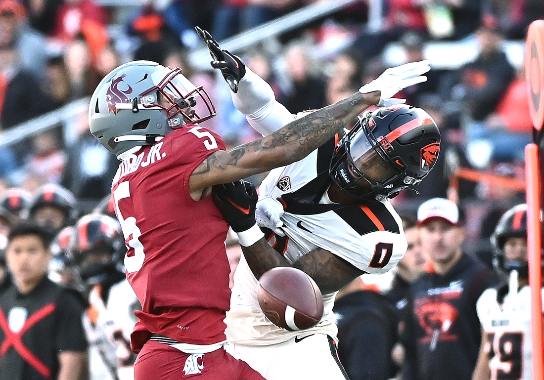 Oct 9, 2021; Pullman, Washington, USA; Washington State Cougars defensive back Derrick Langford (5) is called for pass interference on his play against Oregon State Beavers wide receiver Tre'Shaun Harrison (0) in the first half at Gesa Field at Martin Stadium. Mandatory Credit: James Snook-USA TODAY Sports