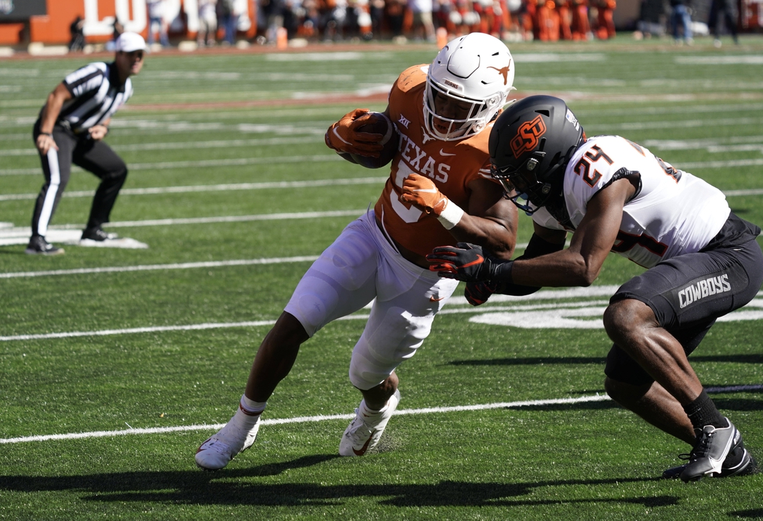 Oct 16, 2021; Austin, Texas, USA; Texas Longhorns running back Bijan Robinson (5) runs for yardage in the red zone in the first half of the game against the Oklahoma State Cowboys at Darrell K Royal-Texas Memorial Stadium. Mandatory Credit: Scott Wachter-USA TODAY Sports