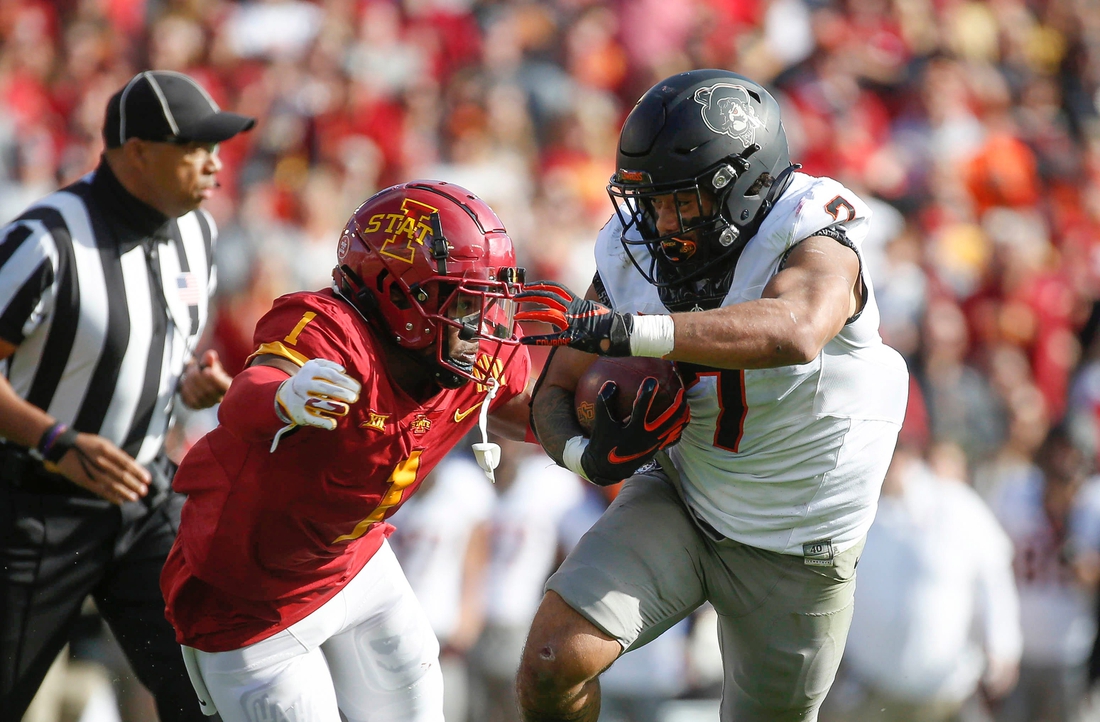 Oklahoma State senior running back Jaylen Warren runs the ball as Iowa State sophomore defensive back Isheem Young applies defense in the first quarter on Saturday, Oct. 23, 2021, at Jack Trice Stadium in Ames.

20211023 Iowastatevsokst