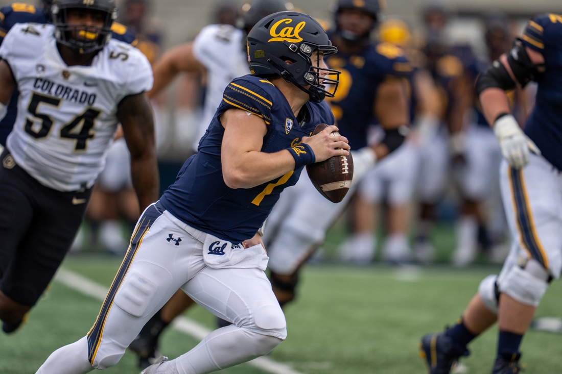 Oct 23, 2021; Berkeley, California, USA; California Golden Bears quarterback Chase Garbers (7) scrambles for the first down and passes the school record held by Joe Kapp for the most rushing yards by a quarterback for the last 60 years against the Colorado Buffaloes during the first quarter at FTX Field at California Memorial Stadium. Mandatory Credit: Neville E. Guard-USA TODAY Sports