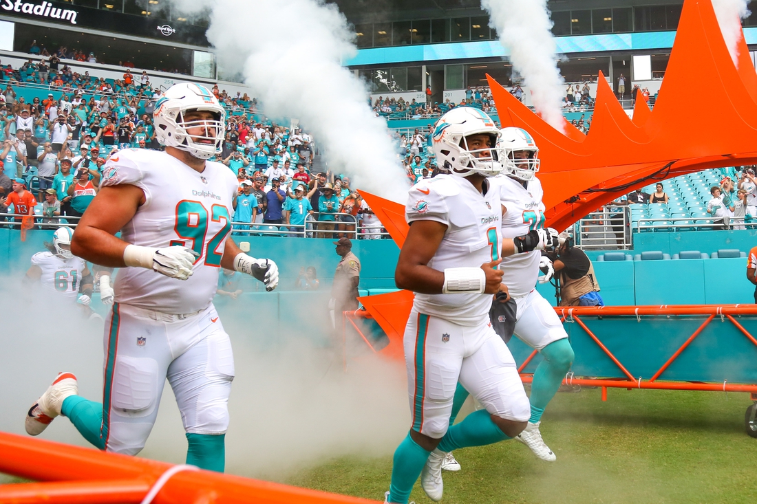 Oct 24, 2021; Miami Gardens, Florida, USA; Miami Dolphins quarterback Tua Tagovailoa (1) takes on the field with defensive end Zach Sieler (92) and offensive tackle Liam Eichenberg (74) prior the game against the Atlanta Falcons at Hard Rock Stadium. Mandatory Credit: Sam Navarro-USA TODAY Sports