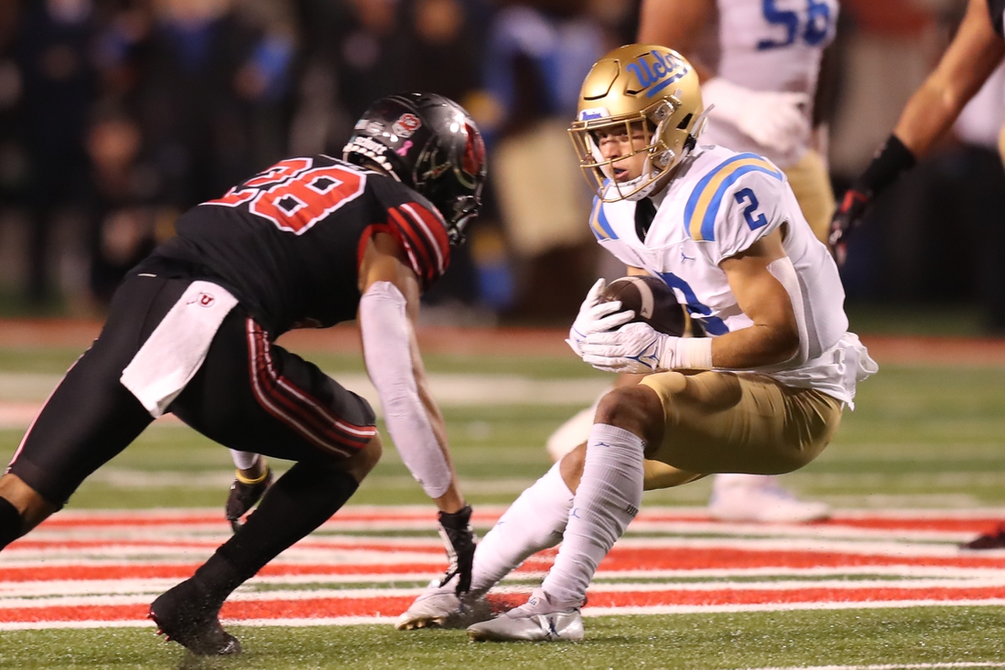 Oct 30, 2021; Salt Lake City, Utah, USA;  UCLA Bruins wide receiver Kyle Philips (2) is tackled by Utah Utes safety Brandon McKinney (28) during the first quarter at Rice-Eccles Stadium. Mandatory Credit: Rob Gray-USA TODAY Sports