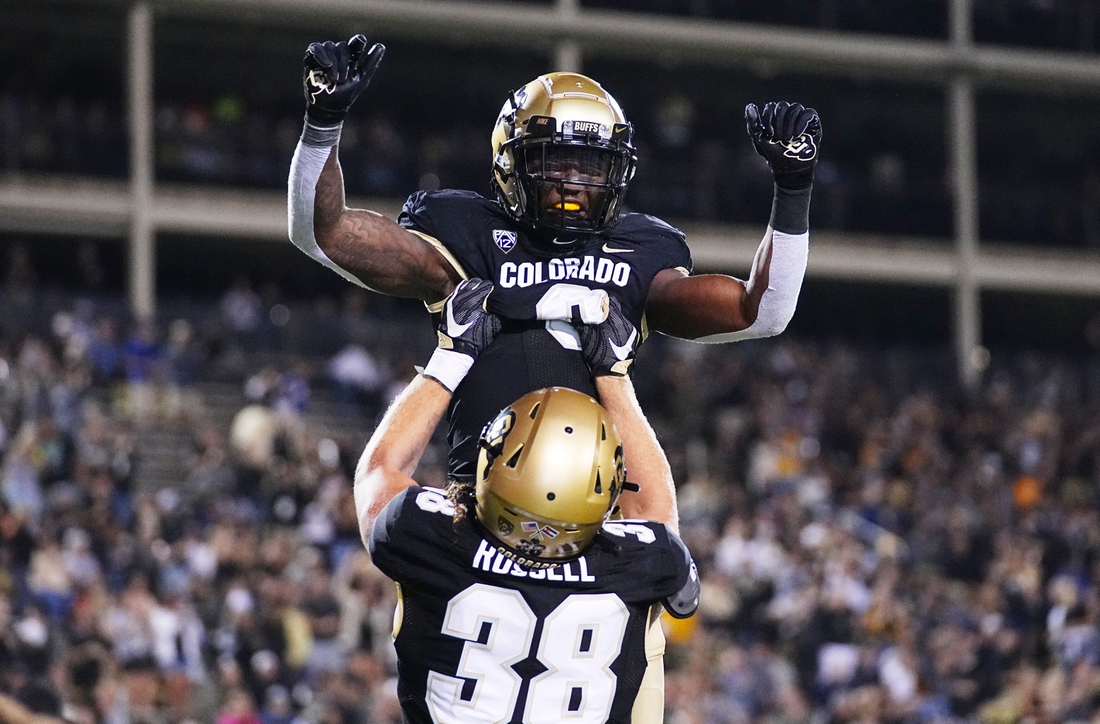 Sep 3, 2021; Boulder, Colorado, USA; Colorado Buffaloes running back Ashaad Clayton (0) and tight end Brady Russell (38) celebrate after a fourth quarter touchdown carry against the Northern Colorado Bears at Folsom Field. Mandatory Credit: Ron Chenoy-USA TODAY Sports