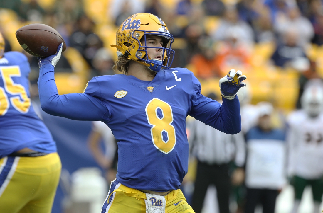Oct 30, 2021; Pittsburgh, Pennsylvania, USA;  Pittsburgh Panthers quarterback Kenny Pickett (8) passes the ball against the Miami Hurricanes during the first quarter at Heinz Field. Mandatory Credit: Charles LeClaire-USA TODAY Sports