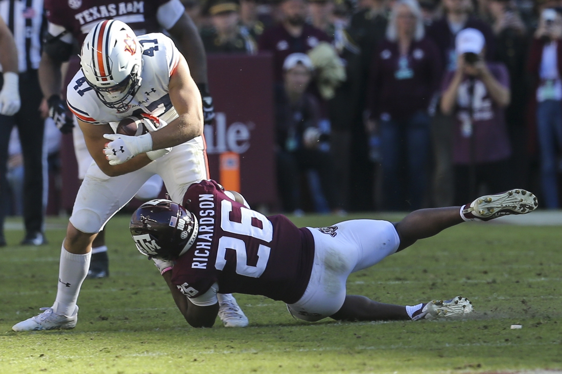 Nov 6, 2021; College Station, Texas, USA;  Auburn Tigers tight end John Samuel Shenker (47) is tacked by Texas A&M Aggies defensive back Demani Richardson (26) in the second quarter at Kyle Field. Mandatory Credit: Thomas Shea-USA TODAY Sports