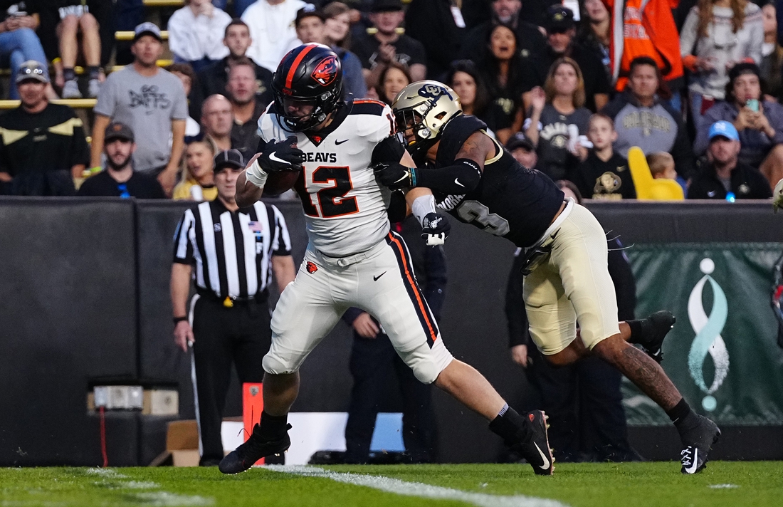 Nov 6, 2021; Boulder, Colorado, USA; Oregon State Beavers linebacker Jack Colletto (12) scores a touchdown past Colorado Buffaloes cornerback Christian Gonzalez (3) in the second quarter at Folsom Field. Mandatory Credit: Ron Chenoy-USA TODAY Sports
