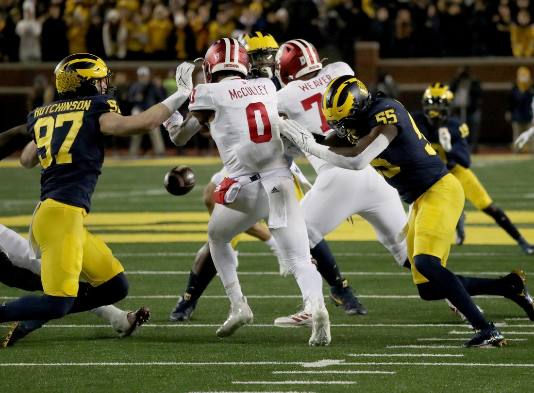 Michigan Wolverines defensive end Aidan Hutchinson (97) and linebacker David Ojabo (55) force a fumble by Indiana Hoosiers quarterback Donaven McCulley (0) during first half action Saturday, Nov. 6, 2021 at Michigan Stadium.

Mich Ind