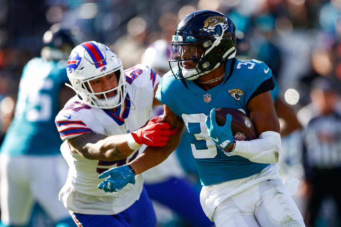 Nov 7, 2021; Jacksonville, Florida, USA;  Jacksonville Jaguars wide receiver Jamal Agnew (39) avoids a tackle from Buffalo Bills defensive end A.J. Epenesa (57) in the second half at TIAA Bank Field. Mandatory Credit: Nathan Ray Seebeck-USA TODAY Sports