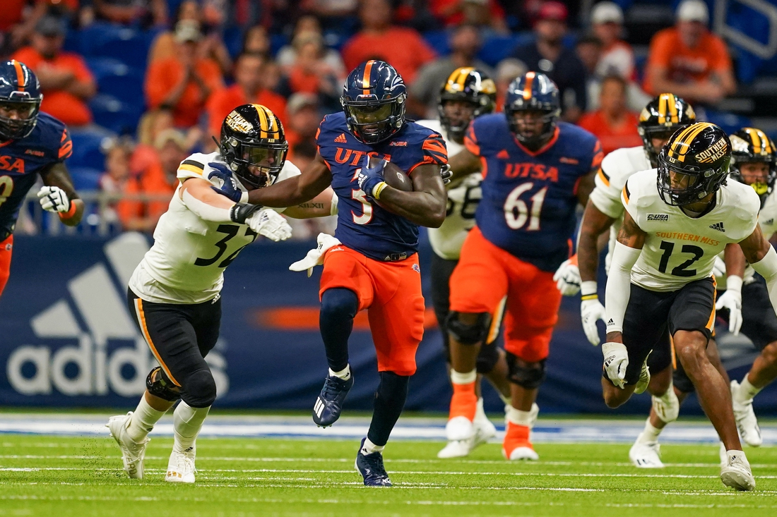 Nov 13, 2021; San Antonio, Texas, USA;  UTSA Roadrunners running back Sincere McCormick (3) fends off Southern Miss Golden Eagles linebacker Hayes Maples (32) in the first quarter at the Alamodome. Mandatory Credit: Daniel Dunn-USA TODAY Sports