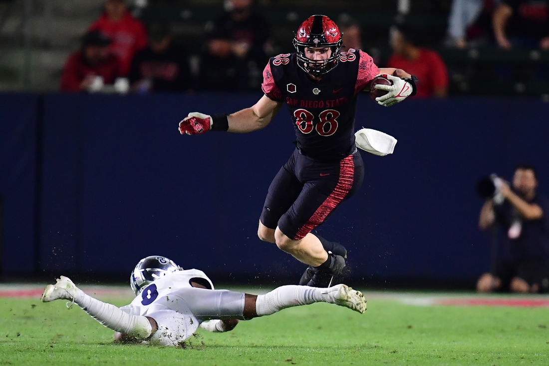 Nov 13, 2021; Carson, California, USA; San Diego State Aztecs tight end Daniel Bellinger (88) runs the ball against Nevada Wolf Pack defensive back JoJuan Clairborne (8) during the first half at Dignity Health Sports Park. Mandatory Credit: Gary A. Vasquez-USA TODAY Sports