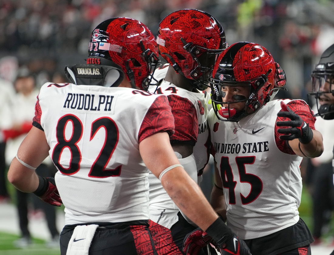 Nov 19, 2021; Paradise, Nevada, USA; San Diego State Aztecs wide receiver Jesse Matthews (45) celebrates with San Diego State Aztecs tight end Jay Rudolph (82) and San Diego State Aztecs wide receiver Tyrell Shavers (14) after scoring a touchdown against the UNLV Rebels at Allegiant Stadium. Mandatory Credit: Stephen R. Sylvanie-USA TODAY Sports