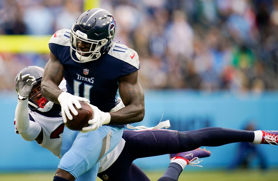 Tennessee Titans wide receiver A.J. Brown (11) pulls in a catch under pressure from Houston Texans cornerback Terrance Mitchell (39) during the first quarter at Nissan Stadium Sunday, Nov. 21, 2021 in Nashville, Tenn.

Titans Texans 2196