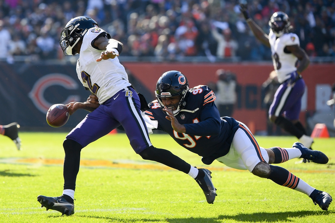 Nov 21, 2021; Chicago, Illinois, USA; Baltimore Ravens quarterback Tyler Huntley (2) fumbles the football against Chicago Bears outside linebacker Robert Quinn (94) in the first half at Soldier Field. Mandatory Credit: Quinn Harris-USA TODAY Sports
