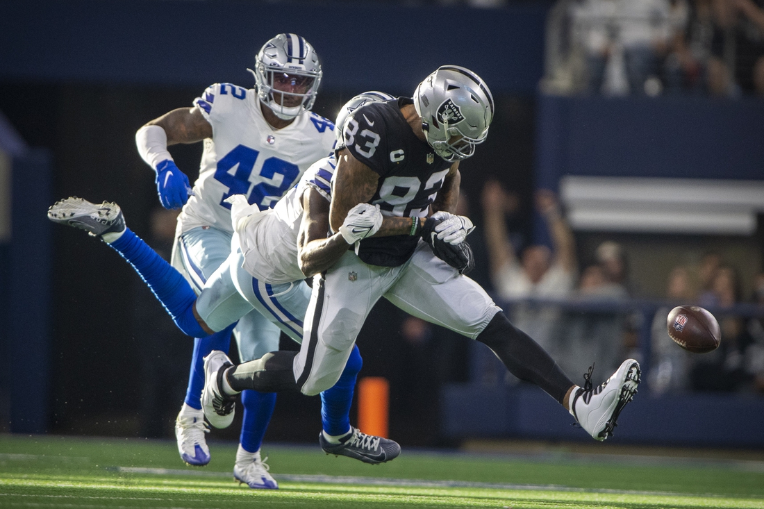 Nov 25, 2021; Arlington, Texas, USA; Las Vegas Raiders tight end Darren Waller (83) drops the ball as he is tackled by Dallas Cowboys safety Jayron Kearse (27) during the first quarter at AT&T Stadium. Mandatory Credit: Jerome Miron-USA TODAY Sports