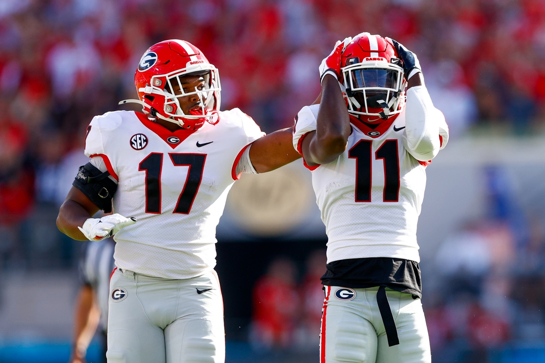 Oct 30, 2021; Jacksonville, Florida, USA;  Georgia Bulldogs defensive back Derion Kendrick (11) and linebacker Nakobe Dean (17) react after a play in the first half against the Florida Gators at TIAA Bank Field. Mandatory Credit: Nathan Ray Seebeck-USA TODAY Sports