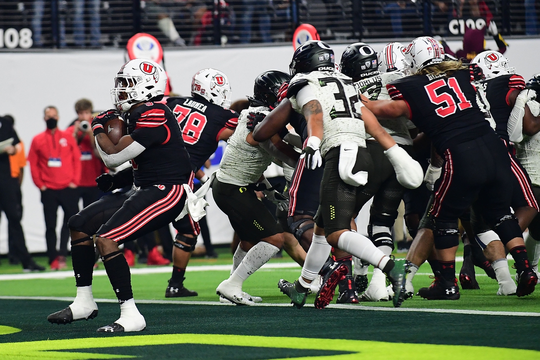 December 3, 2021; Las Vegas, NV, USA; Utah Utes running back Tavion Thomas (9) runs the ball in for a touchdown against the Oregon Ducks during the first half in the 2021 Pac-12 Championship Game at Allegiant Stadium. Mandatory Credit: Gary A. Vasquez-USA TODAY Sports