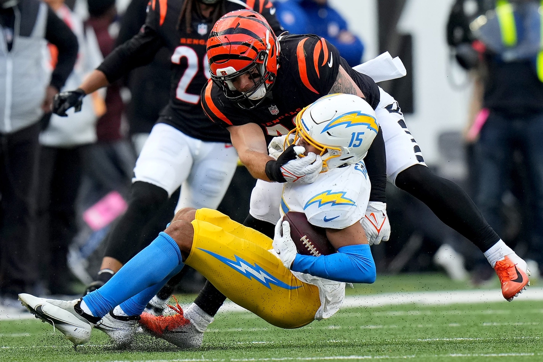 Cincinnati Bengals linebacker Joe Bachie (49) tackles Los Angeles Chargers wide receiver Jalen Guyton (15) in the fourth quarter during a Week 13 NFL football game, Sunday, Dec. 5, 2021, at Paul Brown Stadium in Cincinnati. The Los Angeles Chargers defeated the Cincinnati Bengals, 41-22.

Los Angeles Chargers At Cincinnati Bengals Dec 5