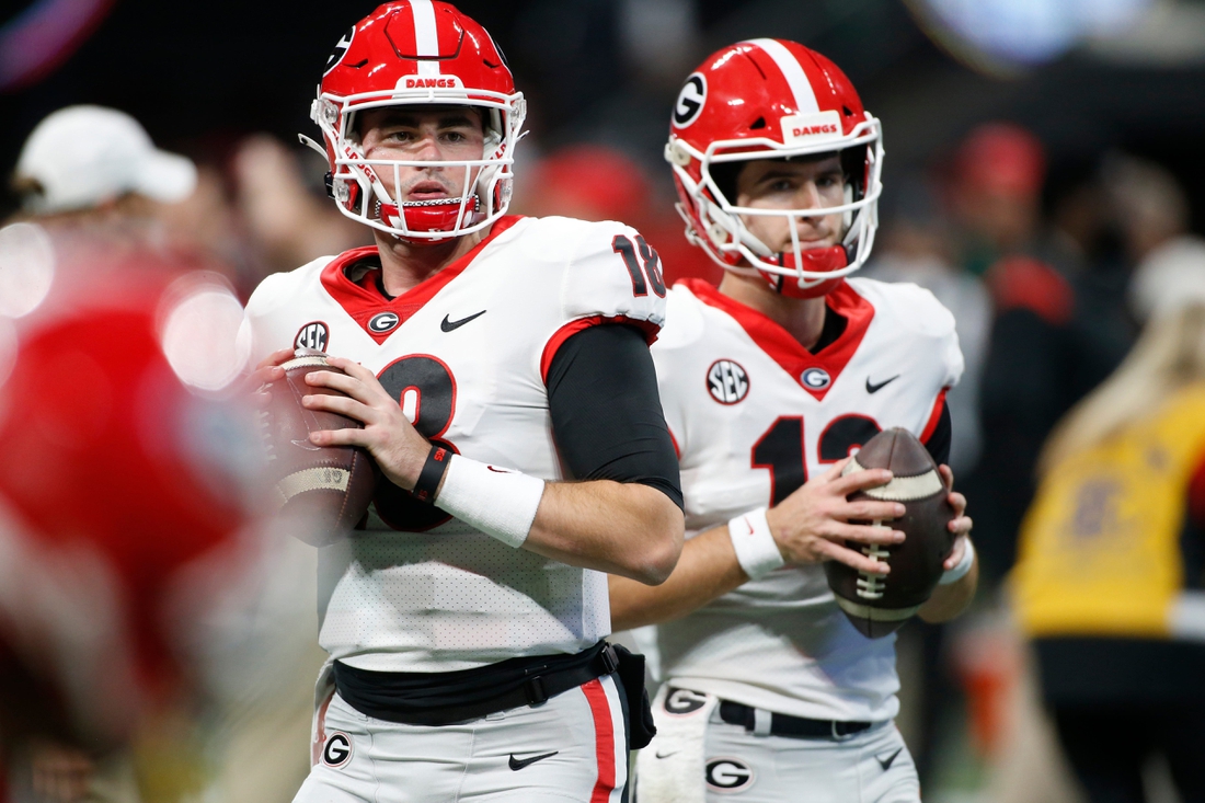 Georgia quarterback JT Daniels (18) and Georgia quarterback Stetson Bennett (13) warm up before the start the Southeastern Conference championship NCAA college football game between Georgia and Alabama in Atlanta, on Saturday, Dec. 4, 2021.

Syndication Online Athens