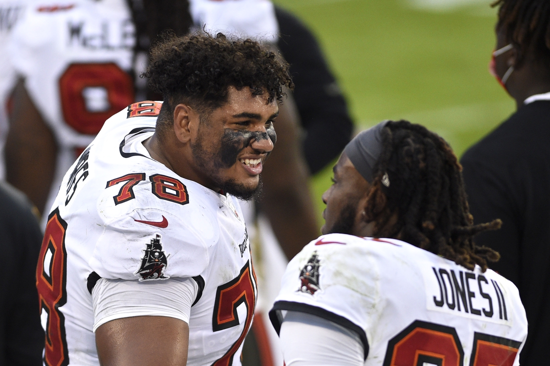 Nov 15, 2020; Charlotte, North Carolina, USA; Tampa Bay Buccaneers offensive tackle Tristan Wirfs (78) talks to running back Ronald Jones (27) on the sidelines in the third quarter at Bank of America Stadium. Mandatory Credit: Bob Donnan-USA TODAY Sports