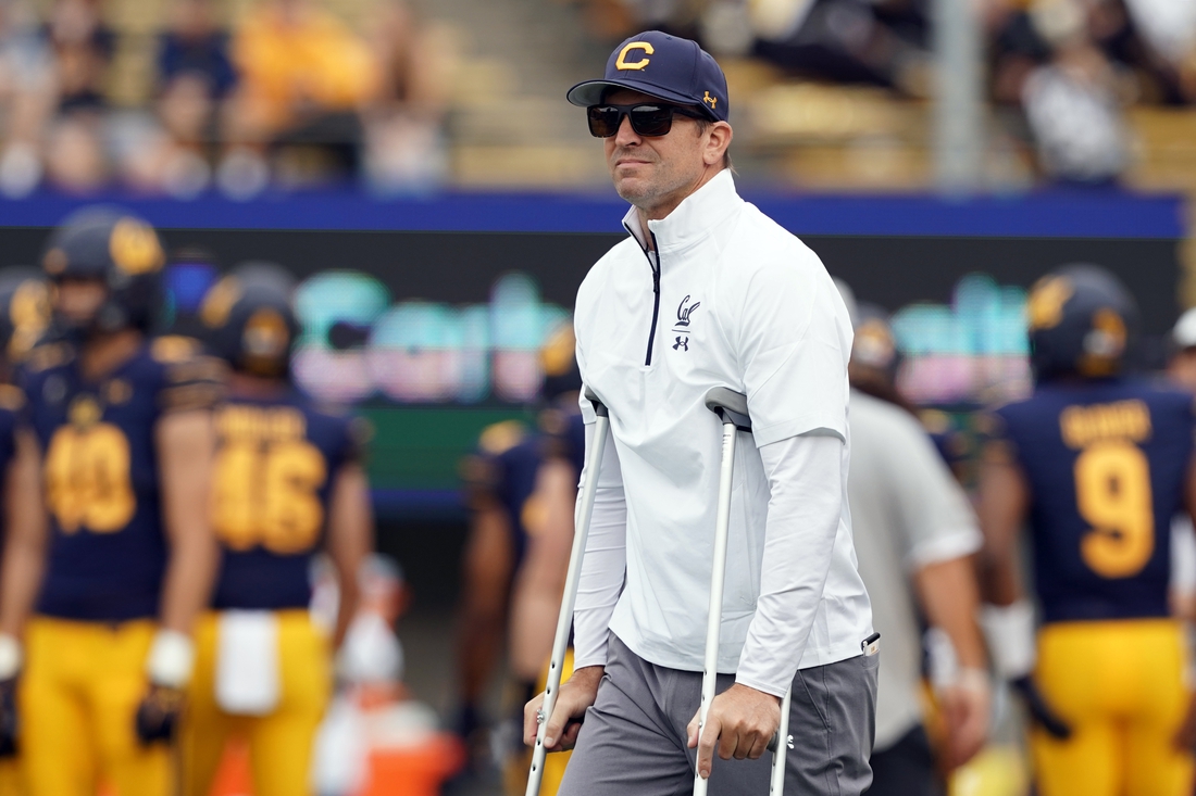 Sep 18, 2021; Berkeley, California, USA; California Golden Bears head coach Justin Wilcox stands on the field with crutches before the game against the Sacramento State Hornets at FTX Field at California Memorial Stadium. Mandatory Credit: Darren Yamashita-USA TODAY Sports