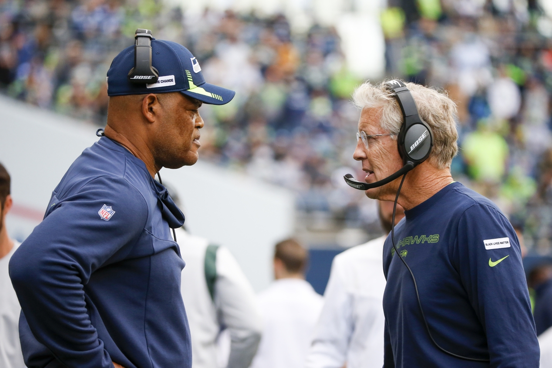 Sep 19, 2021; Seattle, Washington, USA; Seattle Seahawks head coach Pete Carroll, right, talks with defensive coordinator Ken Norton, Jr., left, during the fourth quarter against the Tennessee Titans at Lumen Field. Mandatory Credit: Joe Nicholson-USA TODAY Sports