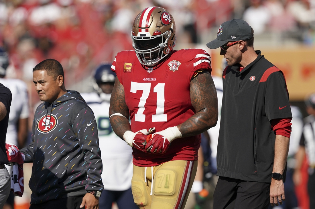 Oct 3, 2021; Santa Clara, California, USA; San Francisco 49ers offensive tackle Trent Williams (71) walks off the field with medical personnel during the fourth quarter against the Seattle Seahawks at Levi's Stadium. Mandatory Credit: Darren Yamashita-USA TODAY Sports