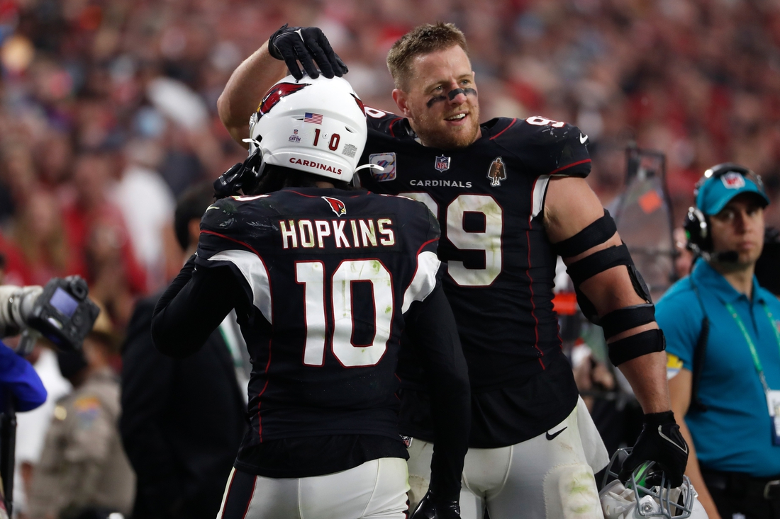 Oct 10, 2021; Glendale, Arizona, USA; Arizona Cardinals defensive end J.J. Watt (99) reacts with wide receiver DeAndre Hopkins (10) after Hopkins scored a fourth quarter touchdown against the San Francisco 49ers at State Farm Stadium. Mandatory Credit: Chris Coduto-USA TODAY Sports