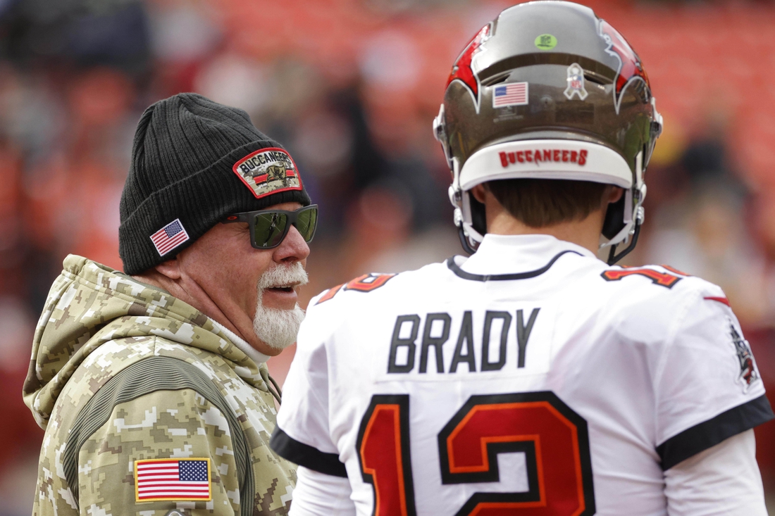Nov 14, 2021; Landover, Maryland, USA; Tampa Bay Buccaneers head coach Bruce Arians (L) talks with Buccaneers quarterback Tom Brady (12) during warmups prior to the game against the Washington Football Team at FedExField. Mandatory Credit: Geoff Burke-USA TODAY Sports