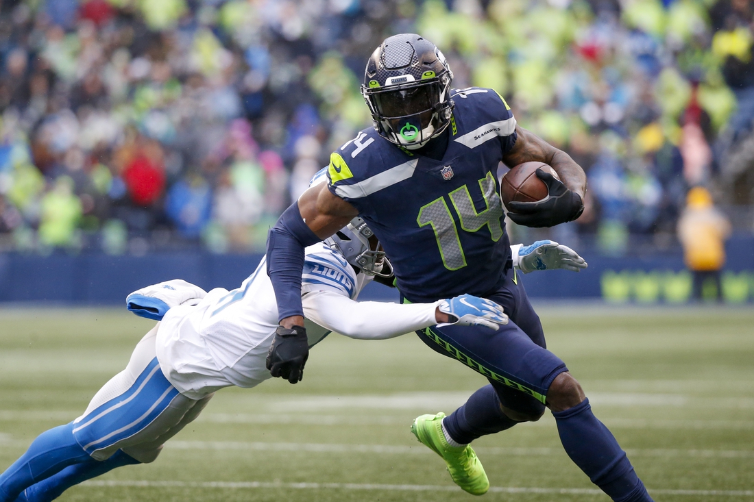 Jan 2, 2022; Seattle, Washington, USA; Seattle Seahawks wide receiver DK Metcalf (14) runs for yards after the catch against the Detroit Lions during the first quarter at Lumen Field. Mandatory Credit: Joe Nicholson-USA TODAY Sports