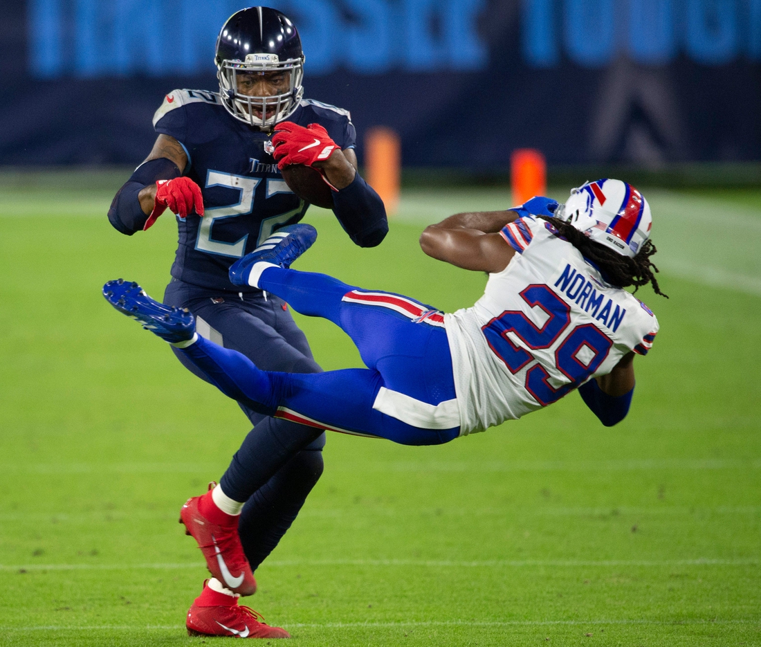 Tennessee Titans running back Derrick Henry (22) throws Buffalo Bills cornerback Josh Norman (29) aside as he rushes up the field during the second quarter at Nissan Stadium Tuesday, Oct. 13, 2020 in Nashville, Tenn.

Nas Titans Bills 001