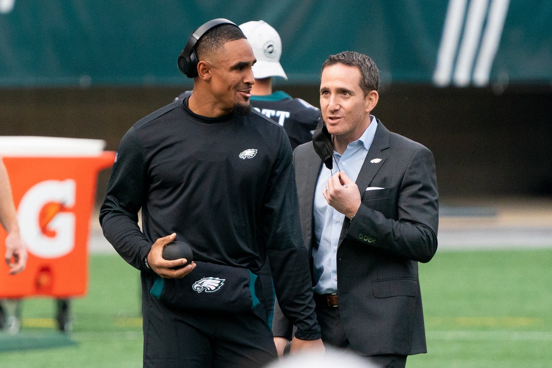 Dec 13, 2020; Philadelphia, Pennsylvania, USA; Philadelphia Eagles quarterback Jalen Hurts (L) talks with general manager Howie Roseman (R) before a game against the New Orleans Saints at Lincoln Financial Field. Mandatory Credit: Bill Streicher-USA TODAY Sports