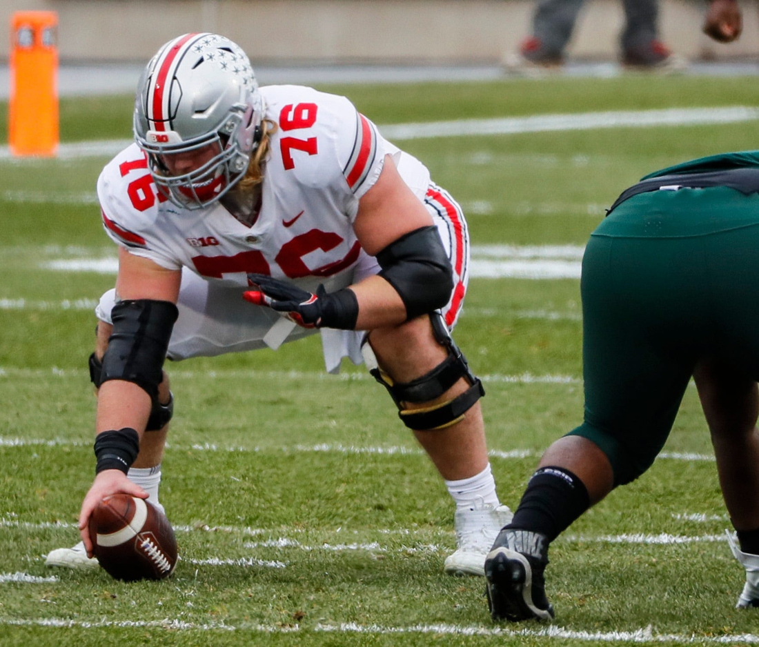 Ohio State Buckeyes offensive lineman Harry Miller (76) prepares to snap the ball during the first quarter of a NCAA Division I football game between the Michigan State Spartans and the Ohio State Buckeyes on Saturday, Dec. 5, 2020 at Spartan Stadium in East Lansing, Michigan.

Cfb Ohio State Buckeyes At Michigan State Spartans