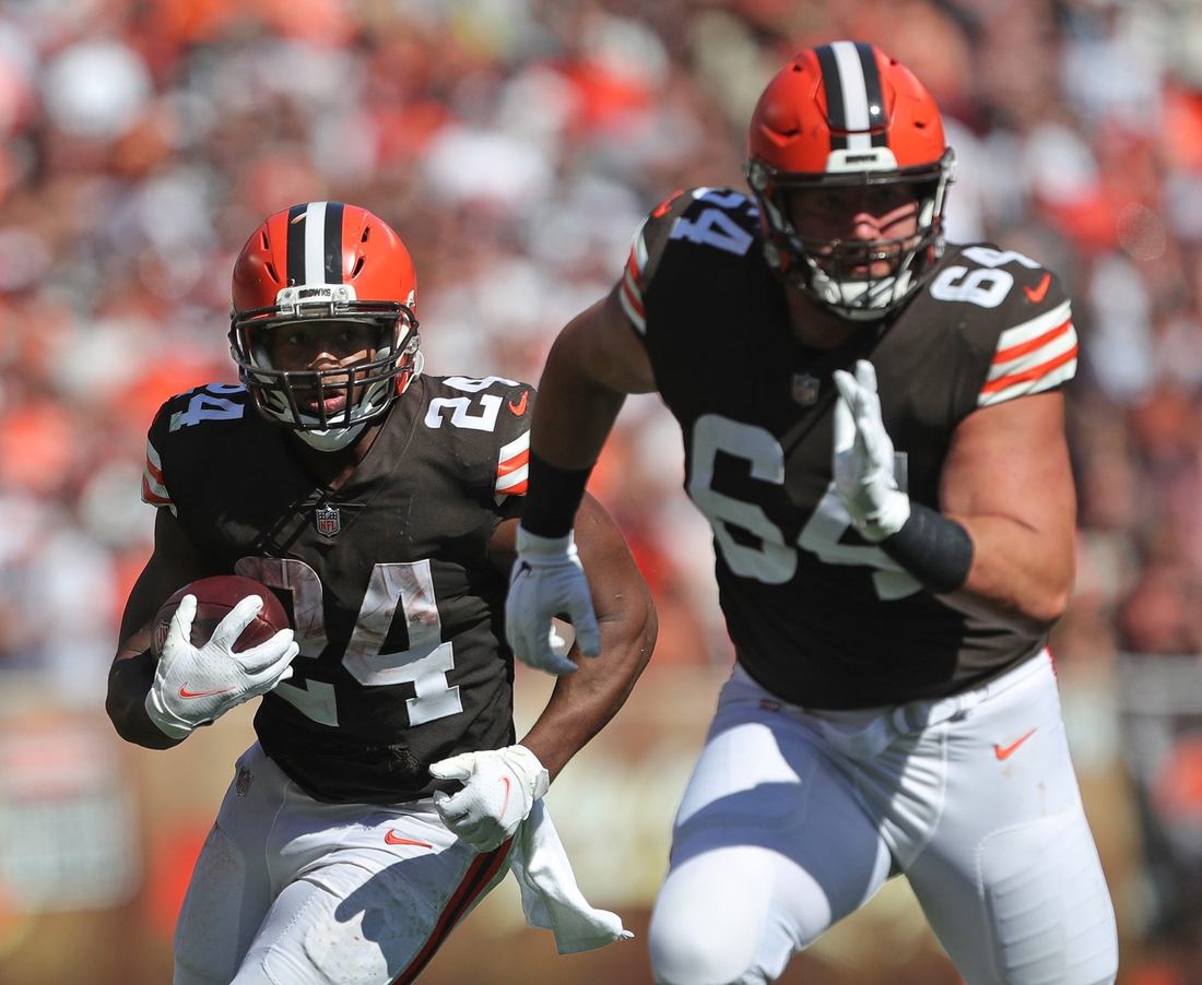 Cleveland Browns running back Nick Chubb (24) rushes for yards behind Cleveland Browns center JC Tretter (64) during the second half of an NFL football game against the Houston Texans, Sunday, Sept. 19, 2021, in Cleveland, Ohio.

Chubb 1