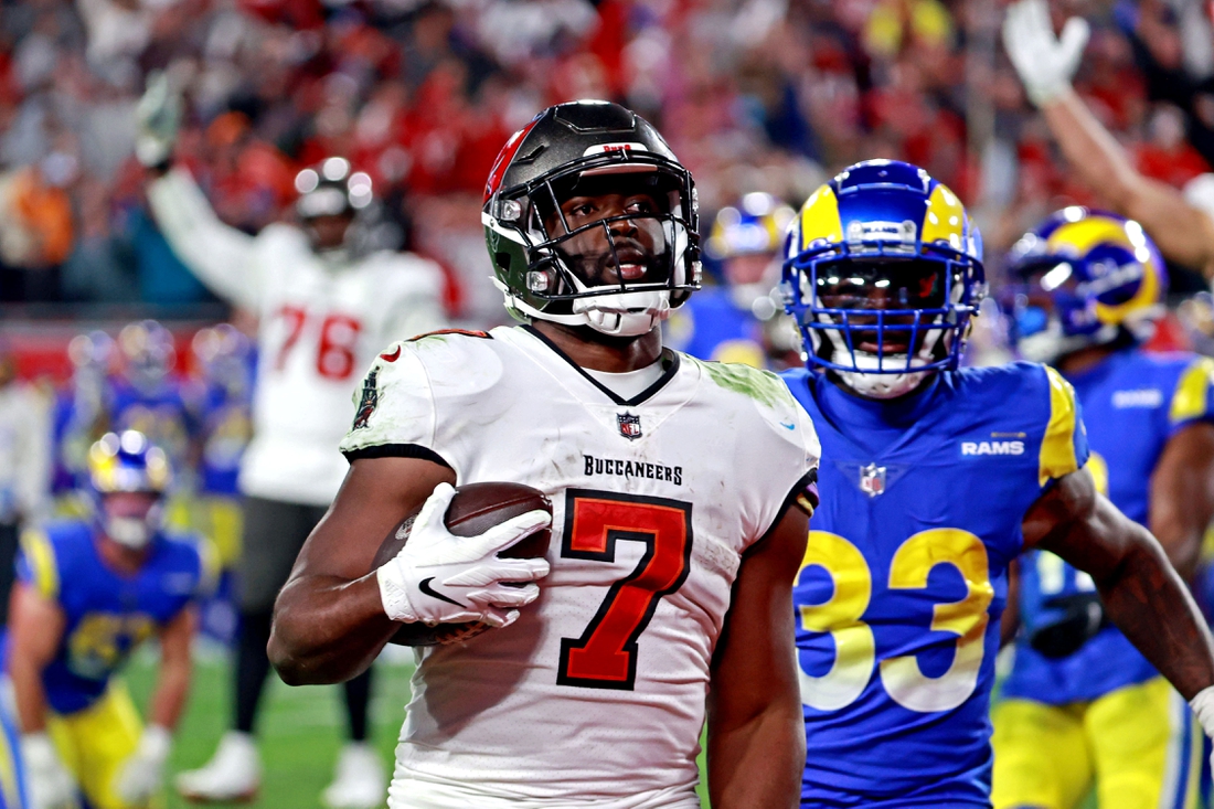 Jan 23, 2022; Tampa, Florida, USA; Tampa Bay Buccaneers running back Leonard Fournette (7) run the ball for a touchdown  against Los Angeles Rams safety Nick Scott (33)  in a NFC Divisional playoff football game at Raymond James Stadium. Mandatory Credit: Matt Pendleton-USA TODAY Sports
