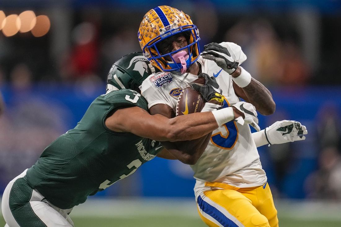 Dec 30, 2021; Atlanta, GA, USA; Pittsburgh Panthers wide receiver Jordan Addison (3) is tackled by Michigan State Spartans safety Xavier Henderson (3) after a long pass reception during the first half during the 2021 Peach Bowl at Mercedes-Benz Stadium. Mandatory Credit: Dale Zanine-USA TODAY Sports
