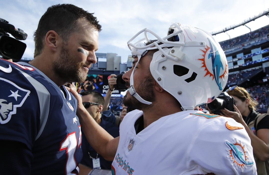 Sep 30, 2018; Foxborough, MA, USA; New England Patriots quarterback Tom Brady (12) and Miami Dolphins wide receiver Danny Amendola (80) meet after the game at Gillette Stadium. The Patriots defeated Miami 38-7. Mandatory Credit: David Butler II-USA TODAY Sports