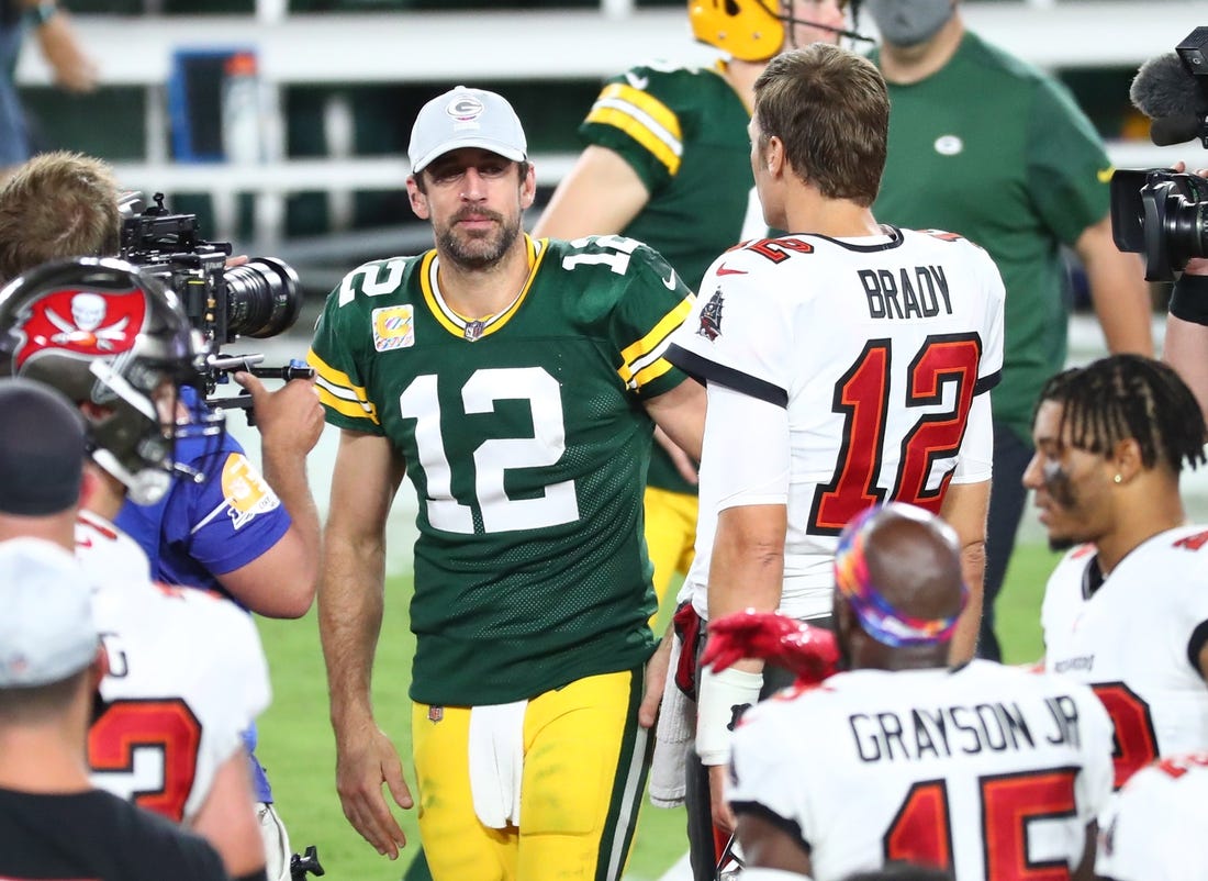 Oct 18, 2020; Tampa, Florida, USA; Tampa Bay Buccaneers quarterback Tom Brady (right) greets Green Bay Packers quarterback Aaron Rodgers (left) after a NFL game at Raymond James Stadium. Mandatory Credit: Kim Klement-USA TODAY Sports