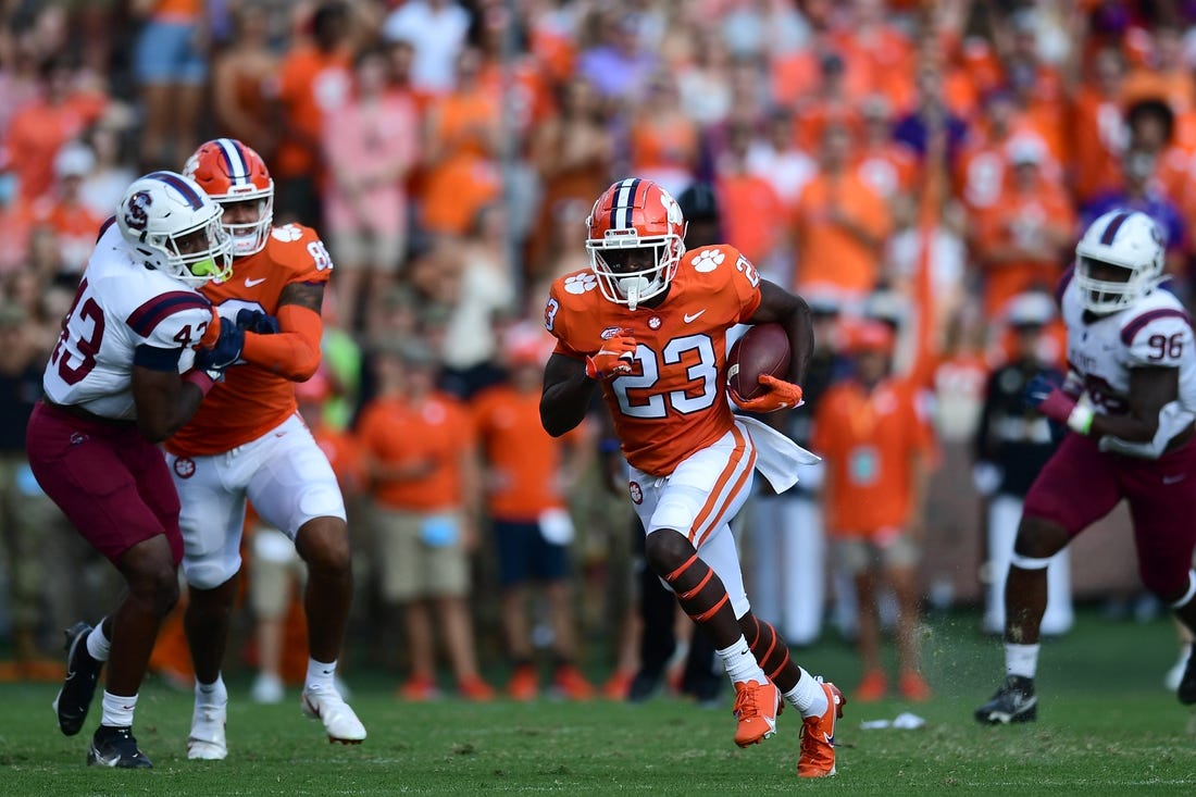 Sep 11, 2021; Clemson, South Carolina, USA; Clemson Tigers running back Lyn-J Dixon (23) carries the ball against the South Carolina State Bulldogs during the first quarter at Memorial Stadium. Mandatory Credit: Adam Hagy-USA TODAY Sports