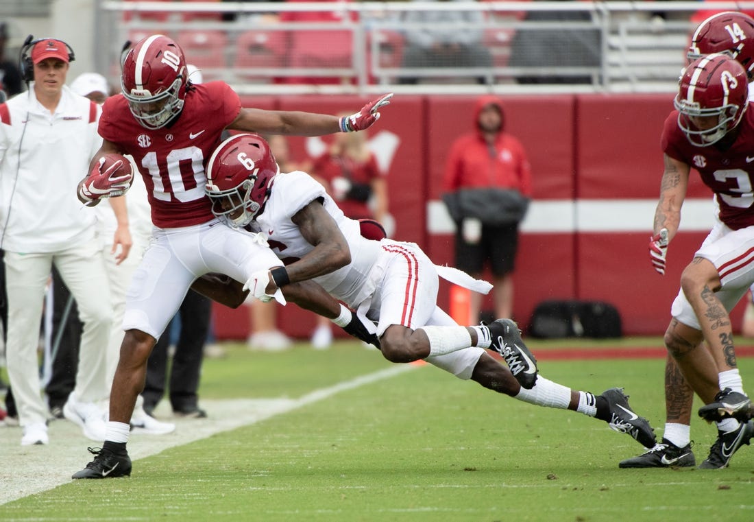 Apr 16, 2022; Tuscaloosa, Alabama, USA; Crimson wide receiver JoJo Earle (10) is driven out of bounds by White defensive back Khyree Jackson (6) during the A-Day game at Bryant-Denny Stadium. Mandatory Credit: Gary Cosby Jr.-USA TODAY Sports
