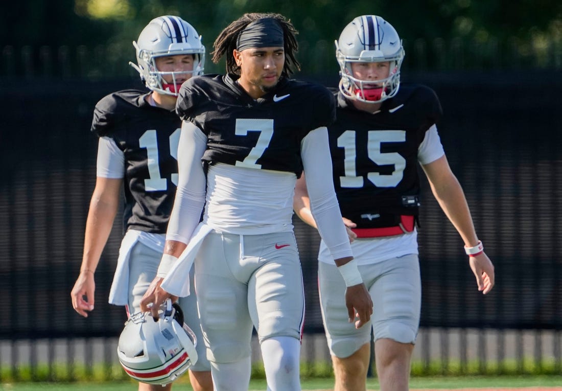 Aug 11, 2022; Columbus, OH, USA;  Ohio State Buckeyes quarterback C.J. Stroud (7) walks with quarterback Devin Brown (15) and quarterback Chad Ray (19) during football camp at the Woody Hayes Athletic Center. Mandatory Credit: Adam Cairns-The Columbus Dispatch

Ohio State Football Camp