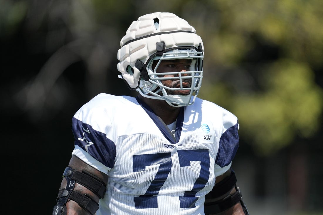 Aug 18, 2022; Costa Mesa, CA, USA;  Dallas Cowboys offensive tackle Tyron Smith (77) wears a Guardian helmet cap during joint practice against the Los Angeles Chargers at Jack Hammett Sports Complex. Mandatory Credit: Kirby Lee-USA TODAY Sports